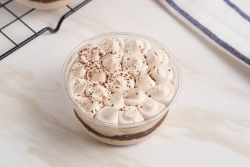 Tiramisu cake decorated with cocoa powder. Close up food. Traditional italian dessert. Perfect for recipe, article, catalogue, or any commercial purposes. with copy space.