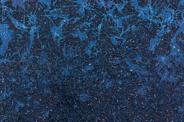 the texture of the ice on the asphalt. first frosts. as a background