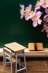 桜と教室のイメージ(黒板と机)