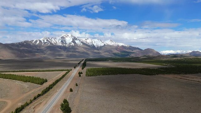 Wide aerial view of highway through Andes mountains in Argentine Patagonia