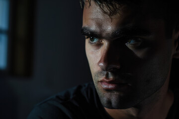 Obraz premium Suspicious Man Staring Intently into Darkness