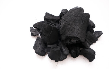 Pile of natural wood charcoal isolated on a white background. Hard wood charcoal.