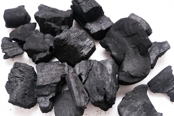 Pile of natural wood charcoal isolated on a white background. Hard wood charcoal.