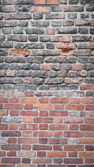 Fototapeta premium Old Brick Wall - Vertical Texture of Red and Gray Bricks, Rustic and Industrial Look, Perfect for Architectural or Decorative Backgrounds