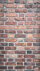 Close-Up of Weathered Brick Wall - Vertical Texture of Rustic Red Bricks and Cement Mortar, Perfect for Backgrounds and Architectural Details