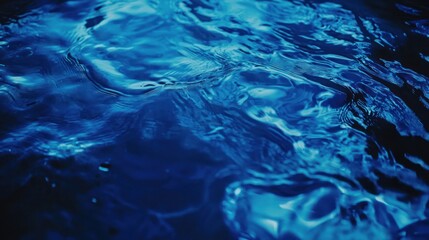 Abstract blue water texture with ripples and reflections.