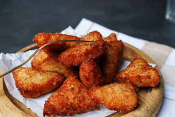 chicken nuggets with red sauce, ketchup, on a dark background with a white kitchen towel, fast food, snack