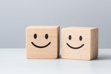 A cheerful face on the illuminated side and a gloomy face on the shadowed side of a wooden cube, representing the selection of a positive outlook.