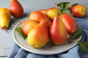 Ripe juicy pears on grey wooden table, closeup