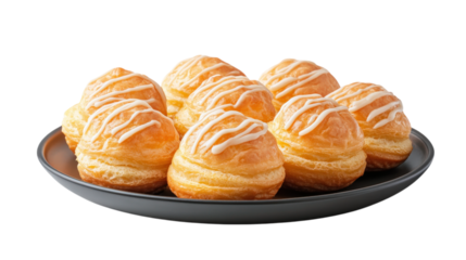 Delicious plate of profiteroles with creamy filling, beautifully arranged and drizzled with icing. Perfect for dessert lovers and special occasions