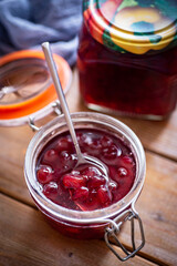 Gooseberry jam in a glass jar. Berry jam for winter in a glass jar. Close-up. vertical photo