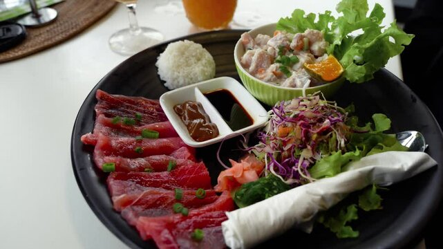Plate Of Tuna Sashimi With Salad And Traditional Cook Island Ika Mata Dish. - closeup shot