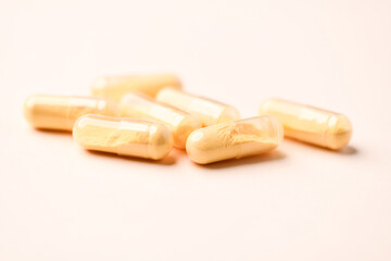 Coenzyme Q10 capsules. Antioxidants. Concept for a healthy dietary supplementation. Bright paper background. Soft focus. Close up. Copy space.