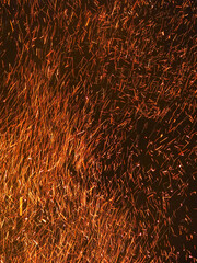 Sparks from a huge bright night bonfire