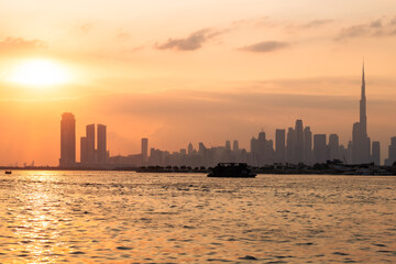 Silhouette of city skyline at sunset, Orange sky, Cruise in river, View from a Yacht