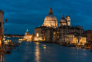 Grand Canal at Night with Lit Santa Maria della Salute Basilica and Waterfront Buildings in Venice