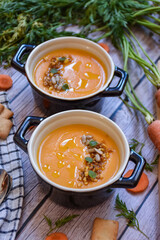 bowl of carrot cream with fresh ingredients. homemade recipe