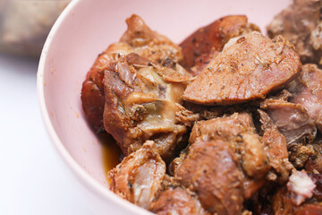 Bowl full of rich, fatty meat. Feast of delicious homemade dinner. Piled roasted meats. Family gathering or special occasion food background. Homemade dinner. Simple meal.