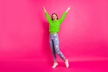 Full body photo of cheerful lady raising her arms wearing yellow pullover dotted denim jeans...
