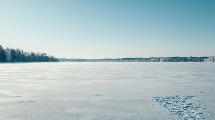 Frozen lake landscape under a clear winter sky.