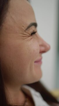Female smiling face, with natural wrinkles. Concept of natural aging.