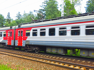 Naklejka premium suburban train passes by a station near Moscow in the summer