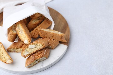 Traditional Italian almond biscuits (Cantucci) on light table, closeup. Space for text