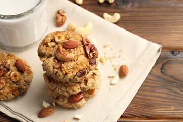 Tasty cookies with nuts on wooden table, closeup