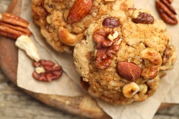 Tasty cookies with nuts on wooden table, top view