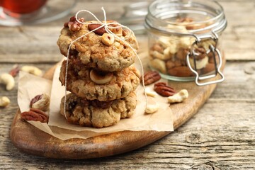 Tasty cookies with nuts on wooden table, closeup