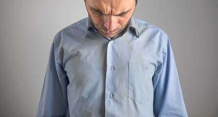 Caucasian man with a dirty business shirt.