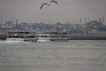 Two ferry boats cross over Golden Horn harbor in Istanbul, Turkey.