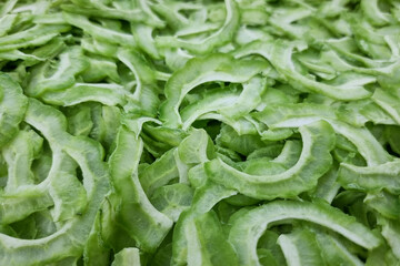 Close-up on slices of freshly cut bitter gourd, perfect as background in graphic pursuit