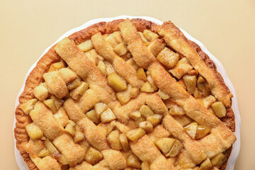 Tasty homemade apple pie on beige background, top view