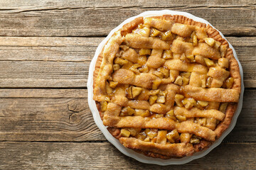 Homemade apple pie on wooden table, top view. Space for text