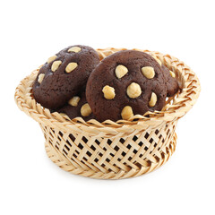 Tasty chocolate cookies with hazelnuts in wicker basket isolated on white