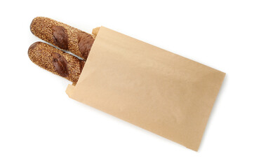 Fresh baguettes with sesame in paper bag isolated on white, top view