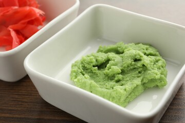 Hot wasabi paste and ginger on wooden table, closeup