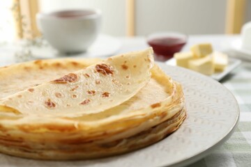Stack of delicious crepes on table, closeup