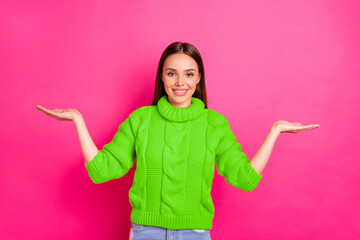 Portrait of cheerful lady hold adverts promo smile wearing yellow jumper isolated over fuchsia...
