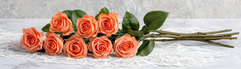 Fototapeta premium Elegant Arrangement of Soft Orange Roses on Lace Background for Wedding or Event Decorations
