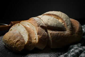 Freshly baked bread on a dark background. Fresh baked goods