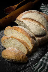 Freshly baked bread on a dark background. Fresh baked goods