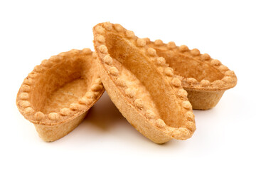 Baked tartlet shell, isolated on white background.