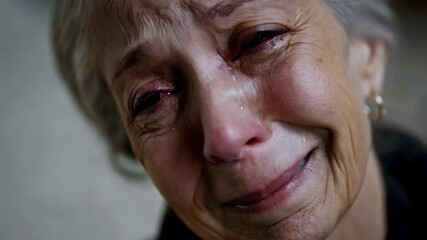 Elderly woman with gray hair shedding silent tears, revealing deep emotional pain and vulnerability through tearful, heartbreaking expression