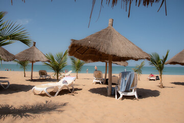 Beautiful beach with thatched parasols in Senegal.