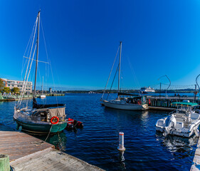 A view past moored boats across the estuary from the waterfront at Halifax, Nova Scotia, Canada in the fall