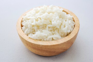Cooked white rice or steamed rice in a wooden bowl,  thai jasmine rice, thai fragrant rice on white table