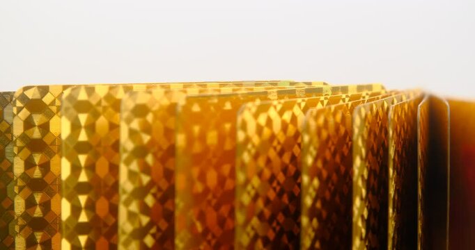 golden playing cards background, back view