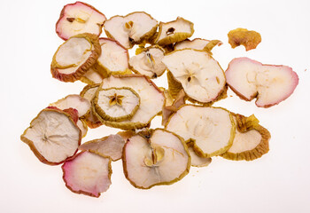 Closeup a pile of dried apple slices isolated on a white background. Healthy raw vegetarian eat from thin fruit chips of sweet and sour flavor